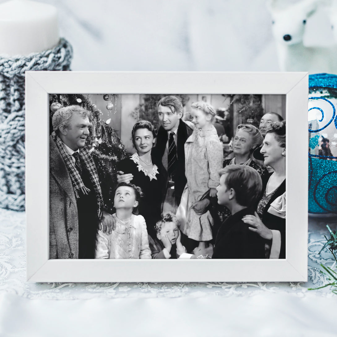Framed black and white photo of a family gathering, surrounded by Christmas decorations, from Frank Capra's 'It's a Wonderful Life'.