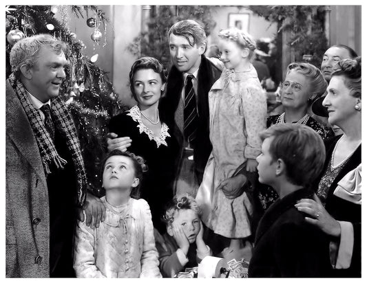 Black and white scene of a family gathered around a Christmas tree